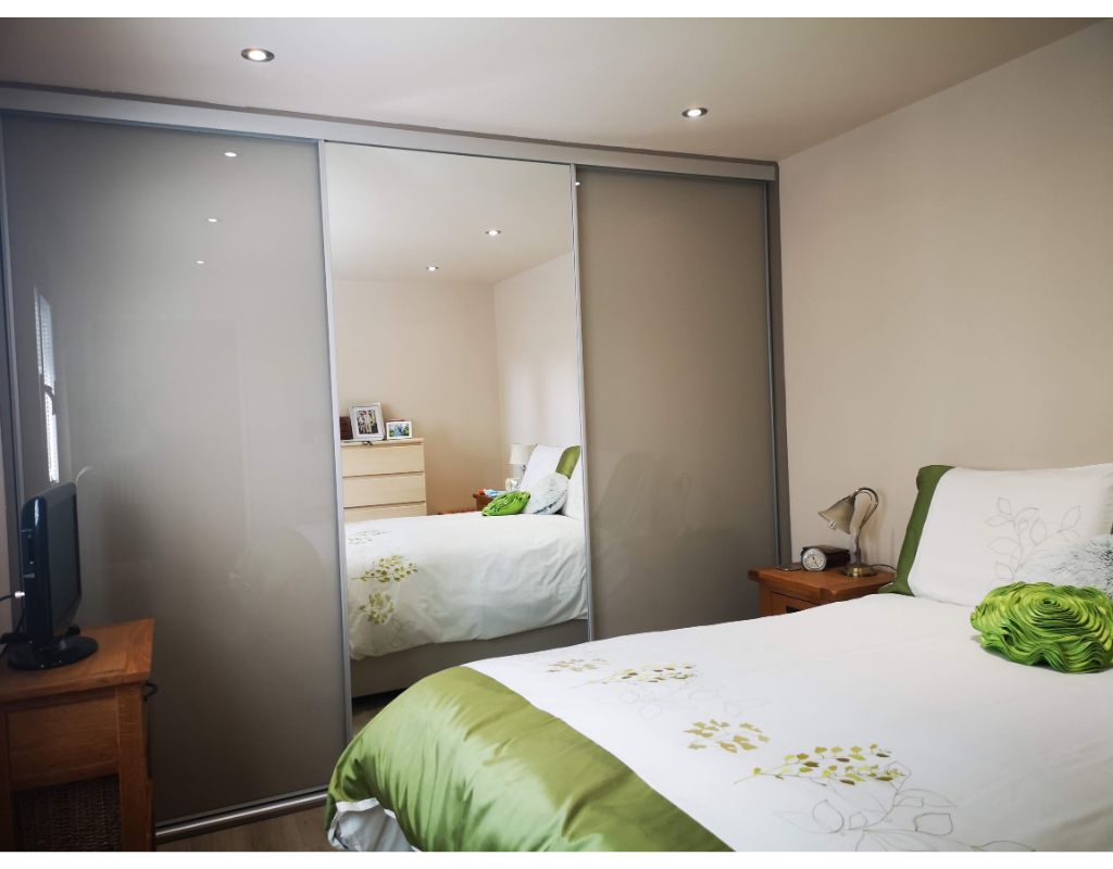 Double bedroom with mirrored sliding door triple wardrobe